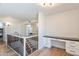 Upstairs hall with modern staircase, built-in desk, and wood floors at 5112 N 35Th St, Phoenix, AZ 85018