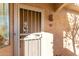 Condo front door with security gate and Southwest design accents at 5450 E Mclellan Rd # 234, Mesa, AZ 85205