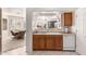Kitchen with wood cabinets, white appliances, and view to dining area at 5450 E Mclellan Rd # 234, Mesa, AZ 85205