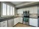 Updated kitchen featuring stainless steel appliances and mosaic backsplash at 706 E Washington St # 202, Phoenix, AZ 85034