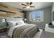 Main bedroom with wood-like accent wall and ceiling fan at 706 E Washington St # 202, Phoenix, AZ 85034