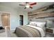 Spacious bedroom with wood-look accent wall and ensuite bathroom at 706 E Washington St # 202, Phoenix, AZ 85034