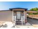 Front view of tan manufactured home with white steps and railing at 952 S Esperanza Ave, Mesa, AZ 85208