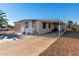 Tan single-wide manufactured home with carport, white railing, and palm tree at 952 S Esperanza Ave, Mesa, AZ 85208