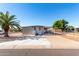 Tan single-wide manufactured home with carport, white railing, and palm tree at 952 S Esperanza Ave, Mesa, AZ 85208