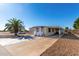 Tan single-wide manufactured home with carport, white railing, and palm tree at 952 S Esperanza Ave, Mesa, AZ 85208