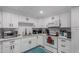Updated kitchen featuring white Shaker cabinets, quartz countertops, and stainless steel appliances at 952 S Esperanza Ave, Mesa, AZ 85208