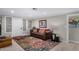 Living room with brown couch, colorful rug, and wood-look floors at 952 S Esperanza Ave, Mesa, AZ 85208