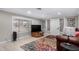 Living room with large TV, colorful rug, and wood-look floors at 952 S Esperanza Ave, Mesa, AZ 85208
