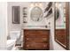 Bathroom with vintage wooden vanity and oval mirror at 1018 W Ivanhoe St, Chandler, AZ 85224