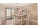 Bright dining room with white table and chairs, offering pool views at 1018 W Ivanhoe St, Chandler, AZ 85224