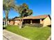 Ranch-style home with mature landscaping and a large grassy yard at 1018 W Ivanhoe St, Chandler, AZ 85224