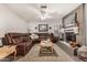 Cozy living room featuring a brown leather sectional sofa and a fireplace at 1018 W Ivanhoe St, Chandler, AZ 85224