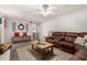 Spacious living room with a brown leather sectional sofa and a wooden coffee table at 1018 W Ivanhoe St, Chandler, AZ 85224