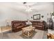 Cozy living room featuring a brown leather sectional sofa and a wooden coffee table at 1018 W Ivanhoe St, Chandler, AZ 85224