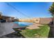 Inviting backyard pool with string lights and a built-in barbecue at 1018 W Ivanhoe St, Chandler, AZ 85224