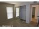 Bedroom with mirrored closet doors and wood-look floors at 11042 N 28Th Dr # 136, Phoenix, AZ 85029