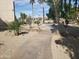 A concrete pathway meanders through a well-maintained desert landscape at 11042 N 28Th Dr # 136, Phoenix, AZ 85029