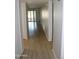 Long hallway with wood-look floors leading to living areas at 11042 N 28Th Dr # 136, Phoenix, AZ 85029