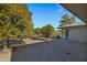 Backyard view showcasing mature trees and gravel at 12424 W Bluestem Dr, Sun City West, AZ 85375