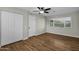 Bedroom with double-door closet and wood-look floors at 12424 W Bluestem Dr, Sun City West, AZ 85375