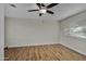 Bedroom with wood-look floors and a ceiling fan at 12424 W Bluestem Dr, Sun City West, AZ 85375