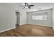 Bright bedroom featuring wood-look floors and a ceiling fan at 12424 W Bluestem Dr, Sun City West, AZ 85375