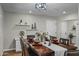 Elegant dining room with dark wood table, modern chandelier, and stylish decor at 12424 W Bluestem Dr, Sun City West, AZ 85375