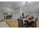 Spacious dining area with a large table, modern lighting, and mirror at 12424 W Bluestem Dr, Sun City West, AZ 85375