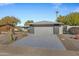 Single story home with gray exterior, landscaping, and a two-car garage at 12424 W Bluestem Dr, Sun City West, AZ 85375