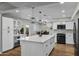 Modern kitchen with white cabinets, quartz countertops, and stainless steel appliances at 12424 W Bluestem Dr, Sun City West, AZ 85375