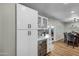 White kitchen cabinets and quartz countertops,wine cooler, and built-in shelving at 12424 W Bluestem Dr, Sun City West, AZ 85375