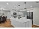 Updated kitchen featuring a large island, white cabinets, and modern fixtures at 12424 W Bluestem Dr, Sun City West, AZ 85375