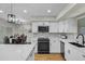 Modern kitchen with white cabinets, quartz countertops and a large island at 12424 W Bluestem Dr, Sun City West, AZ 85375