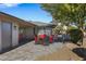 Brick patio with red chairs and a table at 12424 W Bluestem Dr, Sun City West, AZ 85375