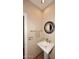 Small powder room with pedestal sink and mirror at 12887 N 135 St, Scottsdale, AZ 85259