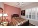 Guest bedroom with striped bedding and a ceiling fan at 12887 N 135 St, Scottsdale, AZ 85259