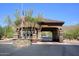 Gated community entrance with guard house and flag at 12887 N 135 St, Scottsdale, AZ 85259