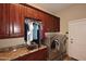 Laundry room with built-in hanging rod and cabinets at 12887 N 135 St, Scottsdale, AZ 85259