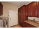 Laundry room with washer, dryer, and wood cabinets at 12887 N 135 St, Scottsdale, AZ 85259