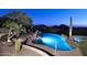 Night view of luxurious pool and spa with mountain backdrop at 12887 N 135 St, Scottsdale, AZ 85259