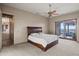 Comfortable bedroom with a wooden bed frame and access to a balcony at 12950 N 119Th St, Scottsdale, AZ 85259