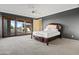 Bright bedroom with a queen-size bed and access to a private patio at 12950 N 119Th St, Scottsdale, AZ 85259