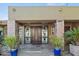 Elegant double door entry with decorative glass and stone accents at 12950 N 119Th St, Scottsdale, AZ 85259