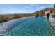 Stunning infinity pool with a waterfall and mountain views at 12950 N 119Th St, Scottsdale, AZ 85259