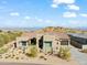 Aerial view of a house with a pool and landscaped backyard, mountain views at 13222 E Ranch Gate Rd, Scottsdale, AZ 85255