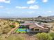 Aerial view of a house with a large backyard, two pools and mountain views at 13222 E Ranch Gate Rd, Scottsdale, AZ 85255