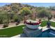 Desert landscape with a pool and lush plants at 13222 E Ranch Gate Rd, Scottsdale, AZ 85255