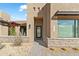 House entrance with a black metal door and stone accents at 13222 E Ranch Gate Rd, Scottsdale, AZ 85255