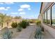 Landscaped backyard with a hot tub and walkway at 13222 E Ranch Gate Rd, Scottsdale, AZ 85255